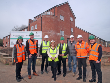 A group outside some new homes in Broxtowe Borough