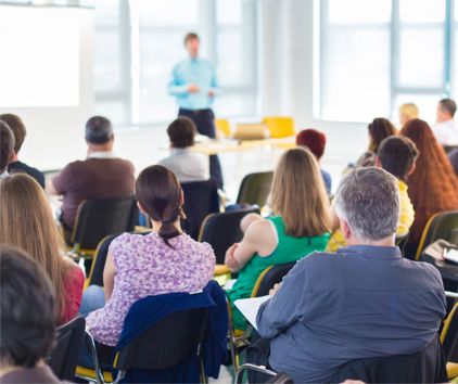 Group of people sitting in a forum meeting