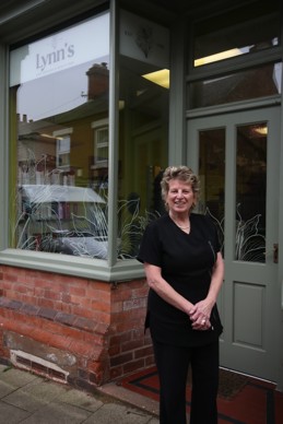 Lynn standing outside Lynn's Hair Designs & Beauty Bar